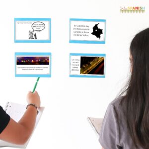 Image shows the back of two teens looking at 4 pieces of paper on the wall. On each piece of paper is a short reading about Mary, the Immaculate Conception, Día de las Velitas in Colombia, and how it is celebrated.